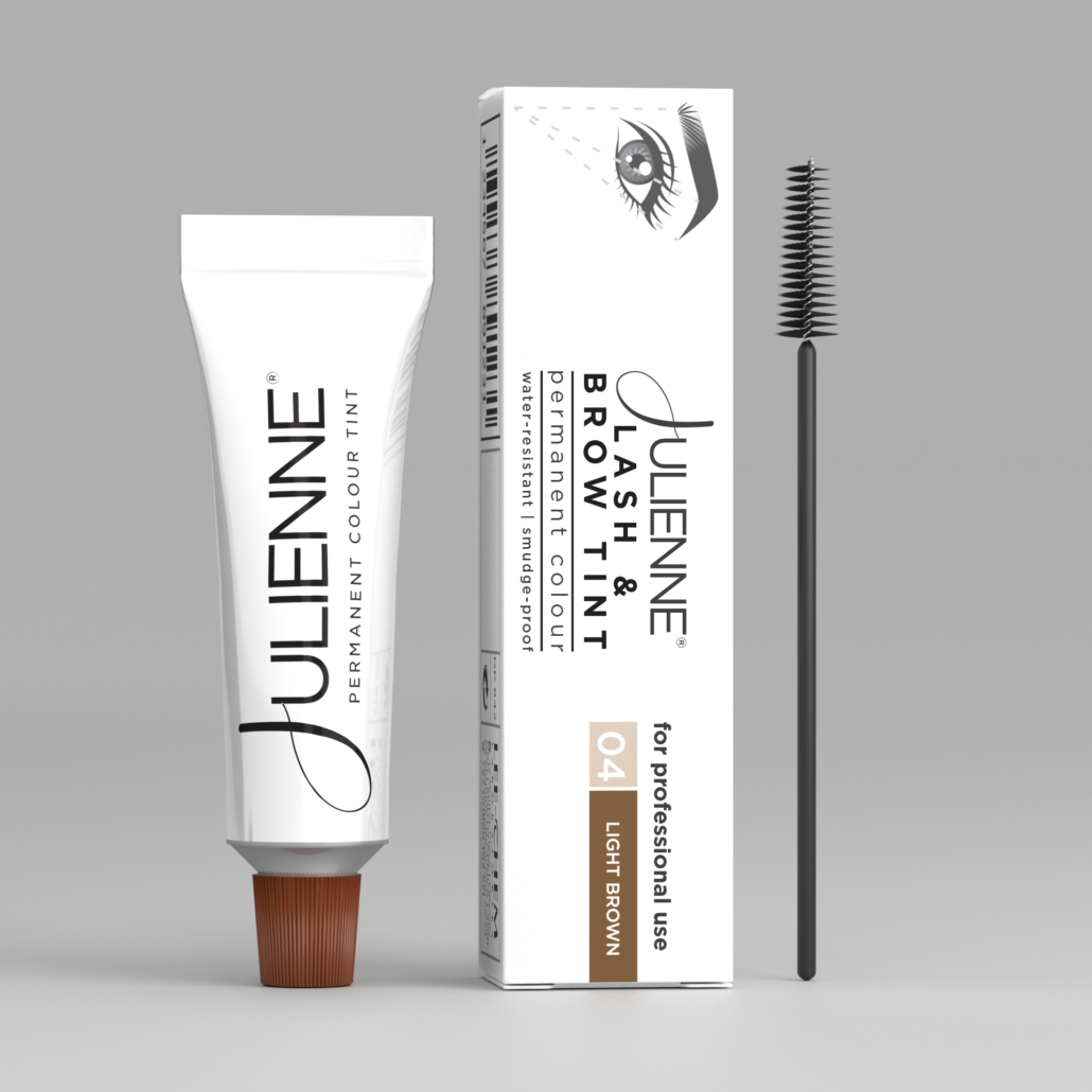 Toothpaste tube with orange cap beside a boxed cosmetic product and a mascara wand on a gray backdrop
